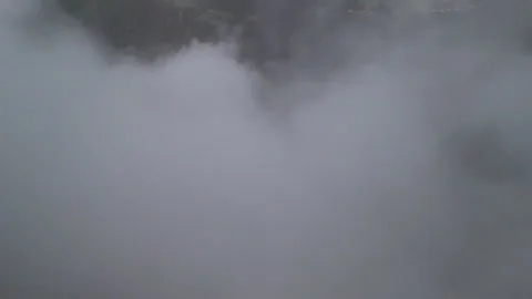 Flying Through Clouds Over Green Mountains in the Early Morning Stock-Footage 277469146