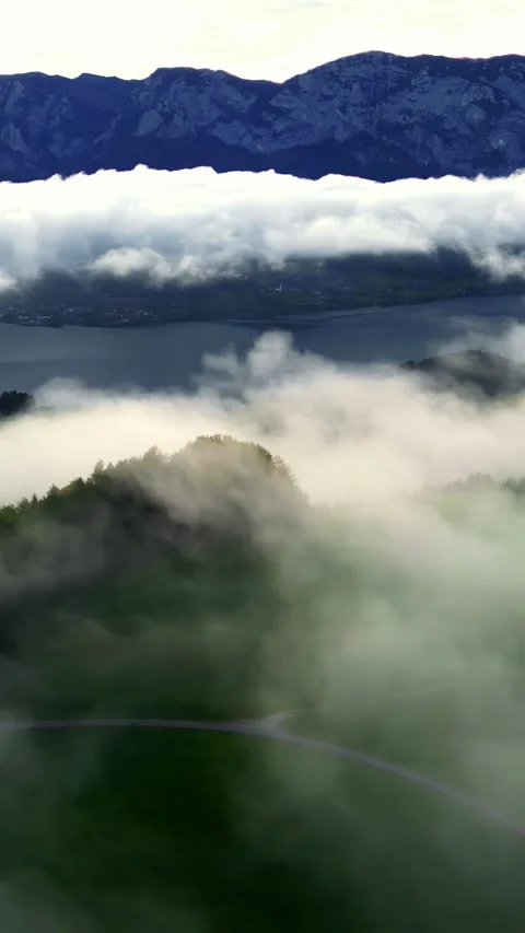 Flying Through Clouds Over Lake Toplitz and Austrian Alps Stock Footage 318391483