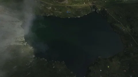 Flying Through Clouds Over Mountain and Lake Stock Footage 94067291