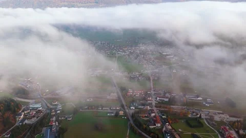 Flying through the clouds over the village in Dolomite Mountains, Italy Stock Footage 315774362