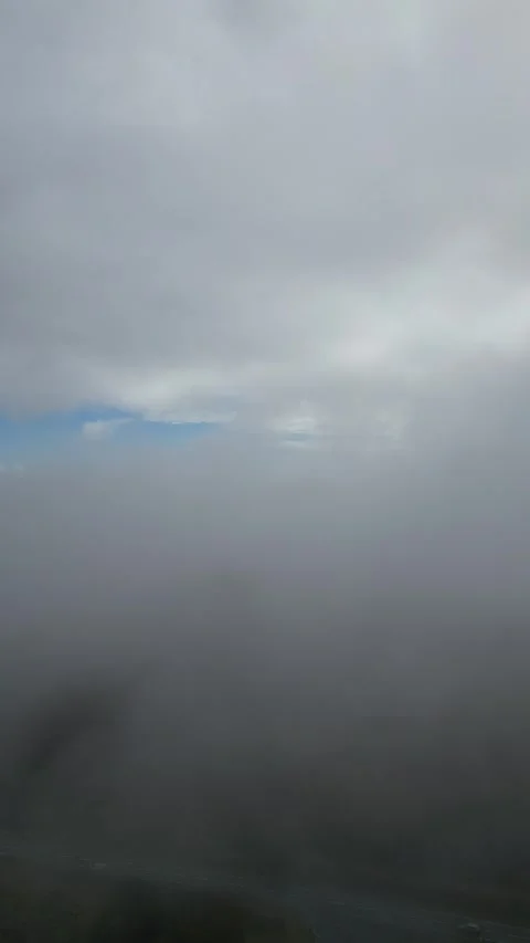 Flying through clouds with road below Stock Footage 334382557