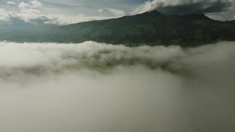 Flying through the clouds to the Rumiñahui volcano. Amazing view of an Stock Footage 272769928