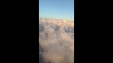 Flying Through Clouds at Sunset to Reveal Terrain Below Aerial Airplane Pas.. Video stock 339295659