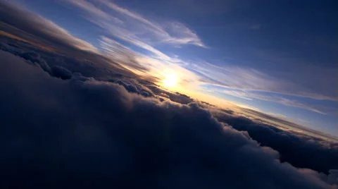 Flying through clouds toward setting sun Stock Footage 59428947