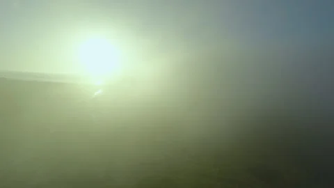 Flying Through Clouds Towards Sun Over Sea Aerial Stock Footage 306316048