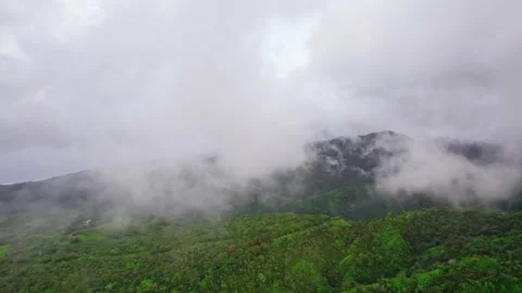 Flying through clouds on a tropical volcanic island. Aerial view of Tahiti. Stock Footage 166204053