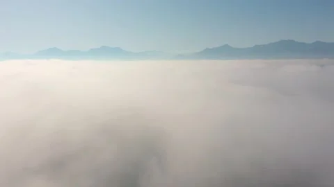 Flying through clouds with view on Alp mountain landscape Stock Footage 148842606