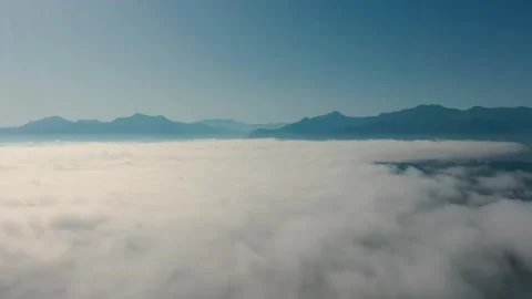 Flying through clouds with view on Alp mountain landscape Stock Footage 148843264