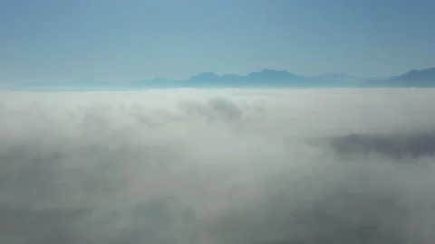 Flying through clouds with view on Alp mountain landscape Stock Footage 148844519