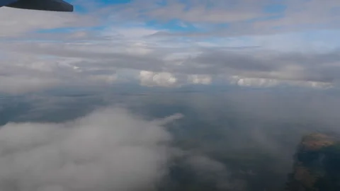 Flying through the clouds, view from the porthole Stock Footage 286053965