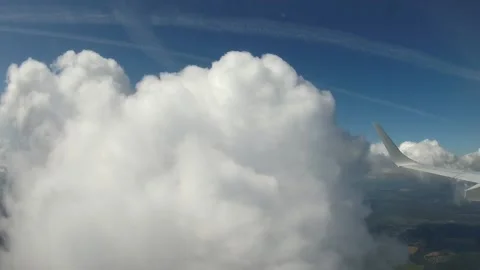 Flying through the clouds on a windy day over Europe. View from the airplane Stock Footage 147034238