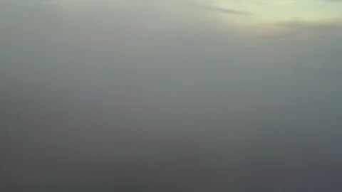 Flying through cloudy, seeing mountains and fog morning sunrise clouds Stock Footage 136753386