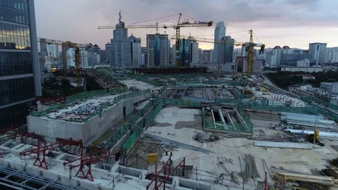 Flying through cranes of construction site reveals skyline Kunming, China Video stock 99071960
