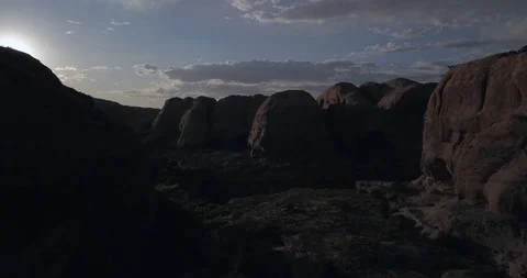 Flying through a dark canyon as the sun peeks over the walls Stock Footage 117864711
