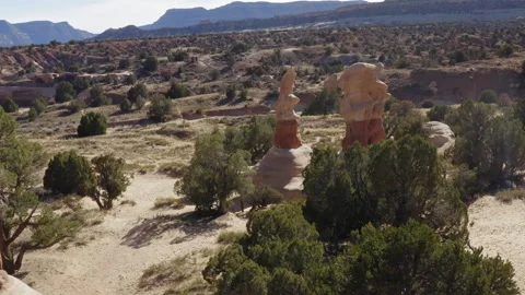 Flying through Devil's Garden Escalante and over two tall hoodoo red rocks 스톡 동영상 248558404