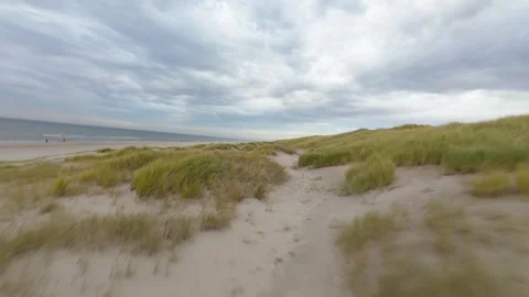 Flying through the dunes and sany beach at the island of Texel, The Netherlands Stock Footage 288377870