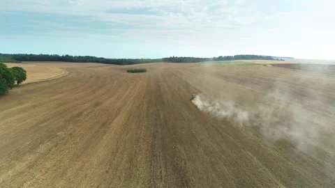 Flying Through Dust Trail Left by Tractor in Dry Field - Haute Marne, France 4K  Stock Footage 259847693