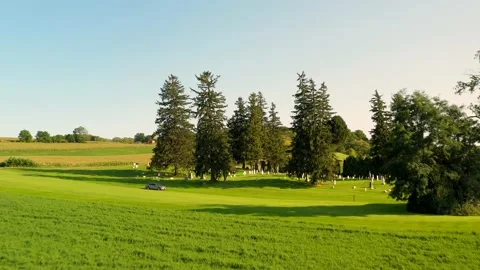 Flying through a field revealing Gorham Cemetery. An old grave yard that Stock Footage 236624990