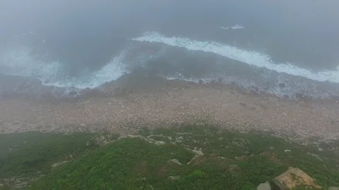 Flying through the fog down to waves breaking into the shore (4k drone footage) Stock Footage 88850018