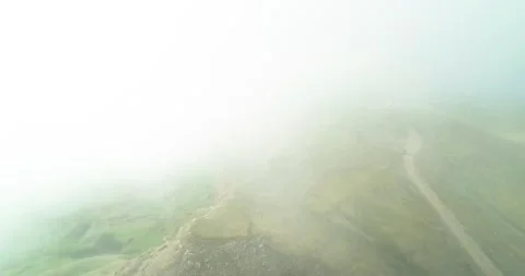 Flying through the fog over high cliffs in the mountains of the North Caucasus Stock Footage 156768989