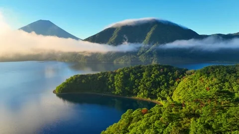 Flying through the fog towards Mount Fuji in the morning over Lake Motosu Stock Footage 248967770