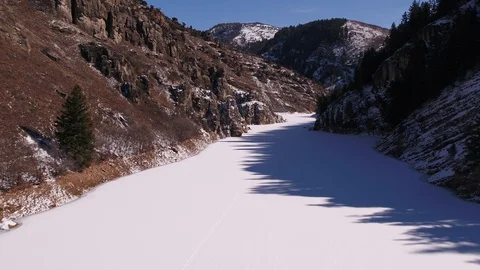 Flying Through Frozen Canyon Over Lake Stock Footage