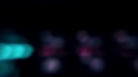 Flying through glowing rose-colored lights on a black screen. Video stock 243208889