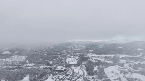 Flying Through Heavy Snowfall Over a Winter Landscape in Korea Stock Footage 344247933