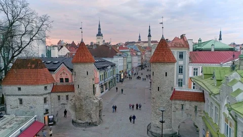 Flying through historical Viru gates in medieval Tallinn old town during sunset Stock Footage 88679447