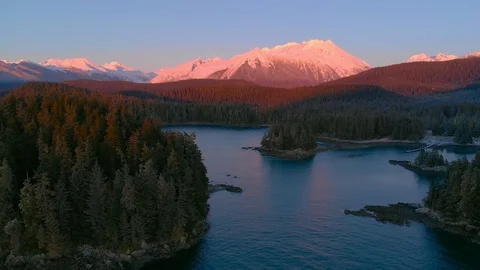 Flying through islands towards sunset mountains Stock Footage 101094114