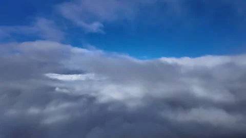Flying Through Layers of Ethereal Clouds in a Blue Sky: Jet Ccokpit Window View Stock Footage 345138930