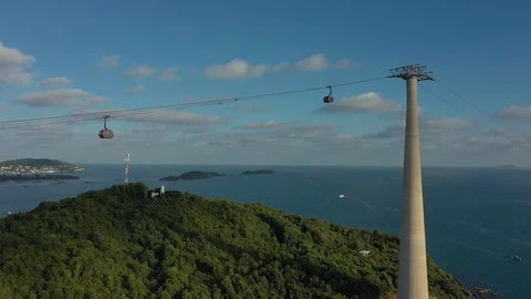 Flying through long cable car very close to approaching one another above mounta Stock Footage 124366084