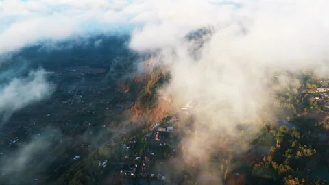 Flying Through Low Clouds Above Green Farmland And Rugged Mountain Slopes In 스톡 동영상 348153556