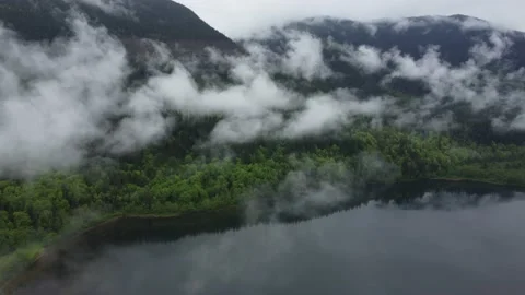 Flying Through Low-Level Clouds Over a Mountain Lake 스톡 동영상 196121481