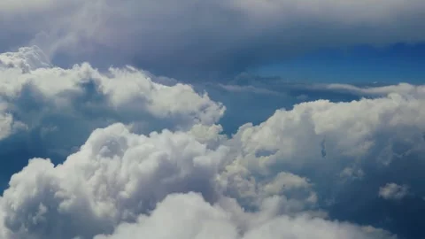 Flying through a majestic cloudscape with cumulus clouds and blue skies, of.. Stock Footage 337351487
