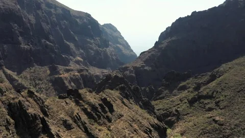 Flying through a Masca Valley around the tall cliffs Video stock 330271769