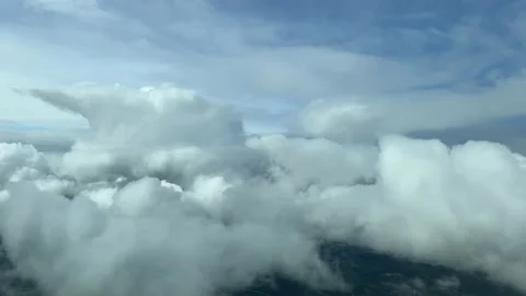 Flying through a messy sky full of tiny cumulus. Pilot point of view. Stock Footage 234482137