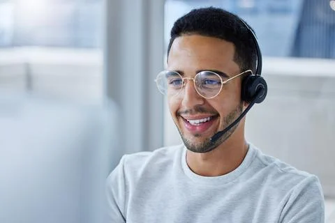 Flying through my workload. Shot of a young businessman working at his desk i Stock Photos