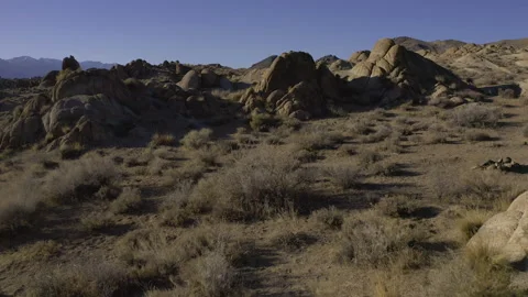 Flying through a narrow rocky gap in the Alabama Hills. Video stock 155086615