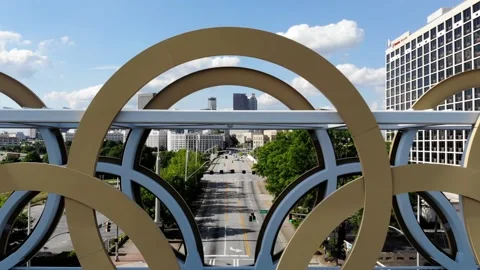Flying Through Olympic Rings into a Cityscape in Atlanta, Aerial View Stock Footage 142305382