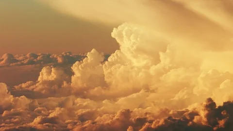 Flying through picturesque cumulus clouds beautifully lit by the evening sun Stock Footage 92163475