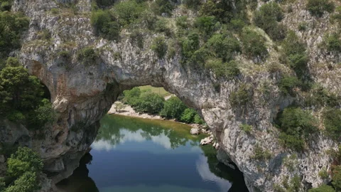Flying through Pont d'arc natural arch river ardeche, France Stock Footage 260190586