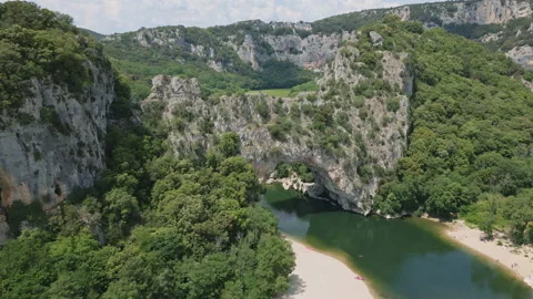 Flying through Pont d'arc natural arch river ardeche, France Stock Footage 260270619