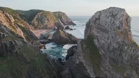 Flying through the rock formations on Praia da Ursa beach. Stock Footage 240500633