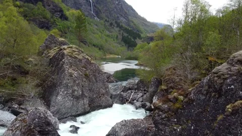 Flying Through Rocks Over River Waterfalls, Beautiful Low Shot - Flåm, Norway Stock Footage 258288915