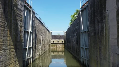 Flying through ship lock on side of hydroelectric powerplant, spring day, 4K Stock Footage 107375322