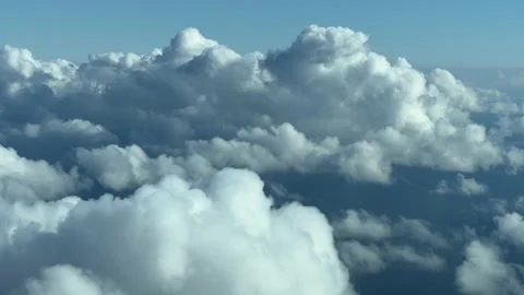 Flying through a sky with some tiny cumulus clouds. Pilot point of view. Stock Footage 234491044