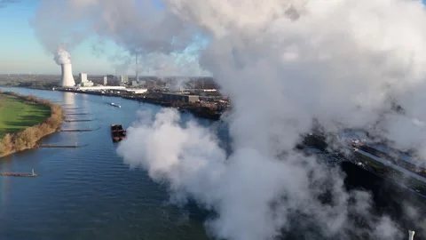 Flying through smoke above river toward power station Stock Footage 331204324