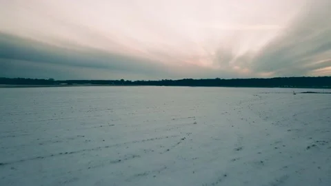 Flying through the snowy field under dramatic sky Stock Footage 170260426
