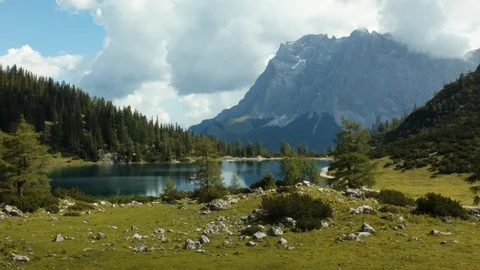 Flying through some trees revealing lake Sebensee Stock Footage 101902508